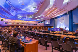 official UN room, with the UN emblem on the wall